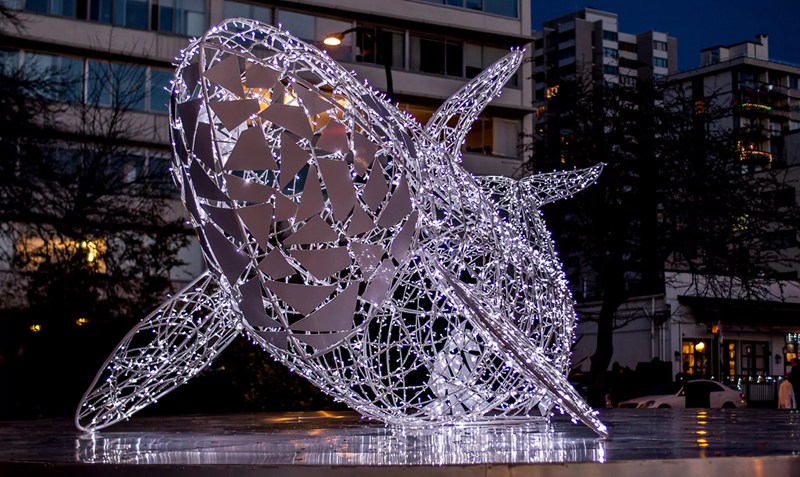 stainless steel whale sculpture with light