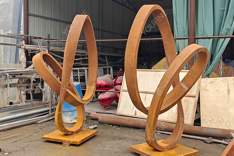 corten steel abstract ring sculpture