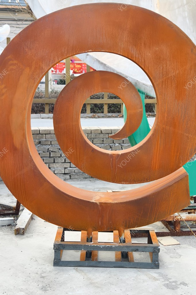 corten steel abstract sculpture in factory