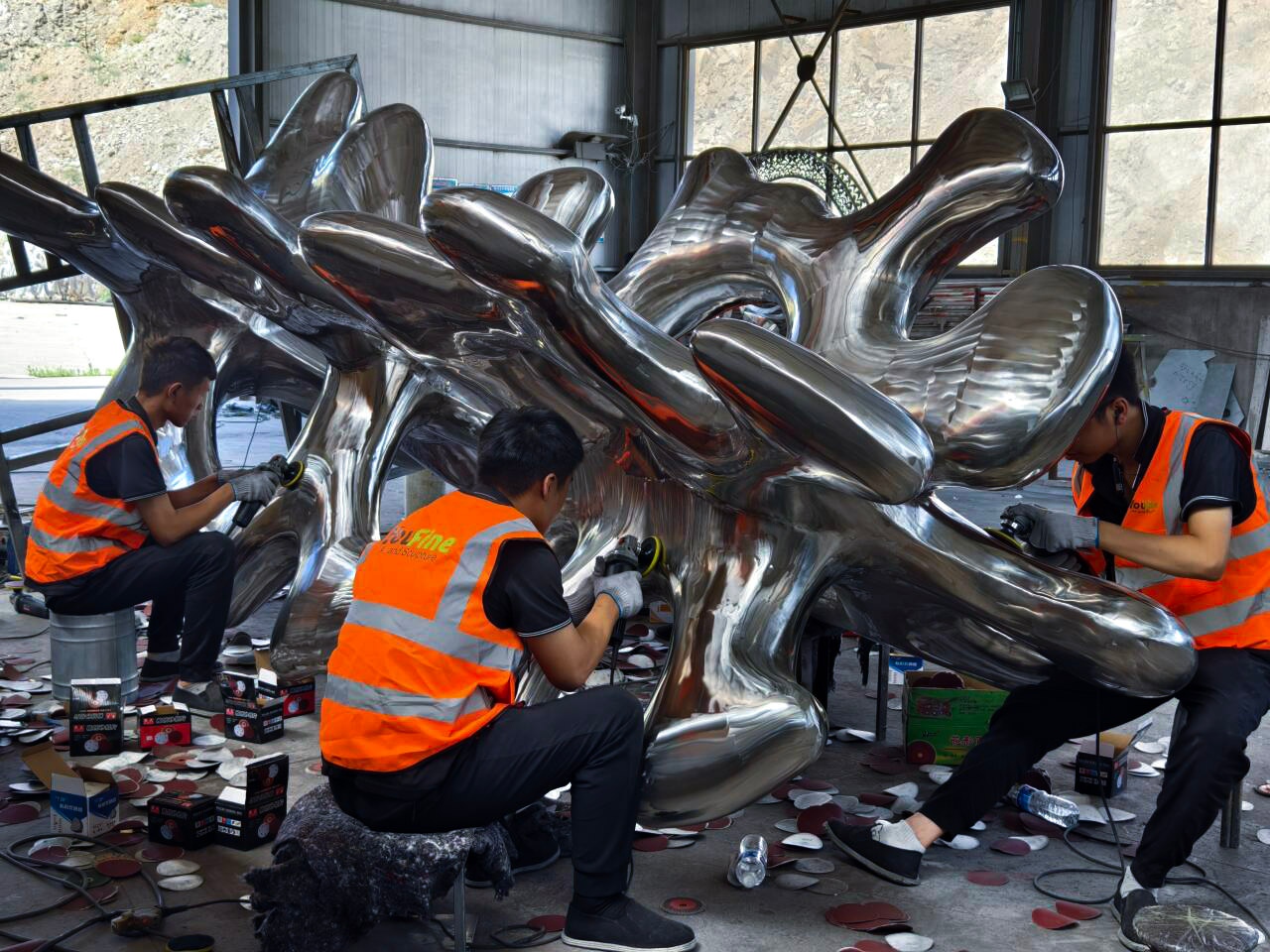 Factory artisans working on a metal sculpture